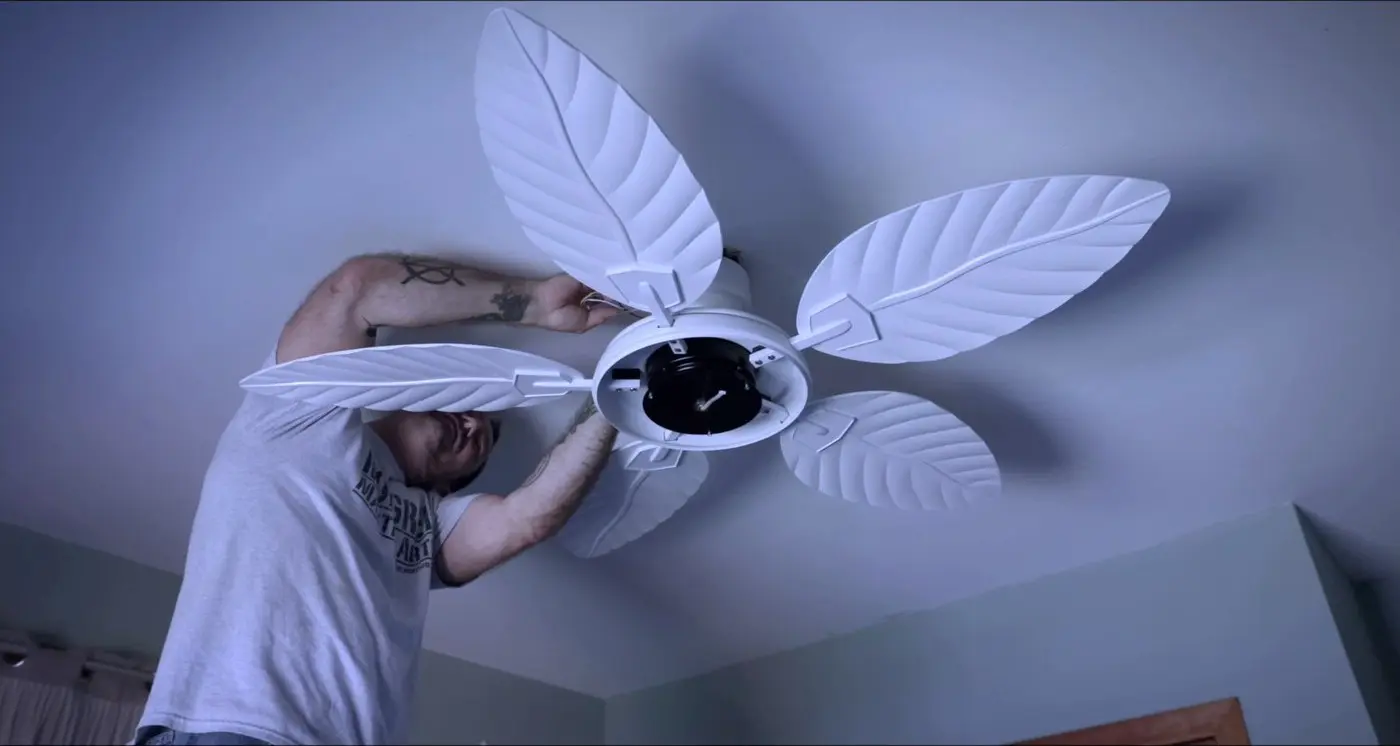 Electrician installing a ceiling fan in a Richmond home
